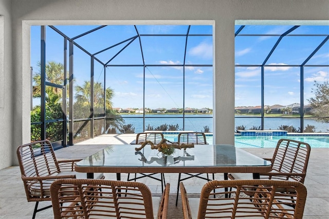 view of patio / terrace with a lanai and a water view