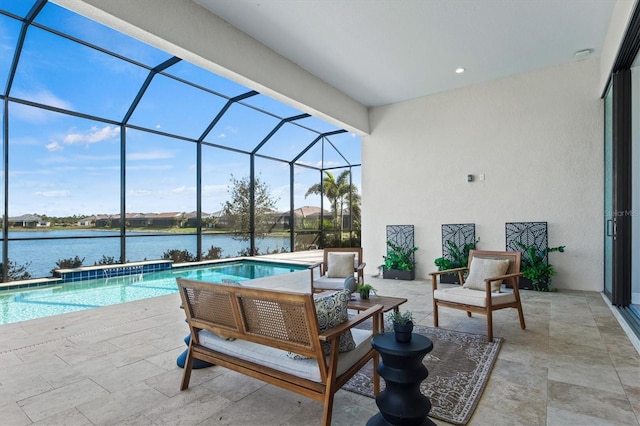 view of swimming pool featuring glass enclosure, a patio area, and a water view