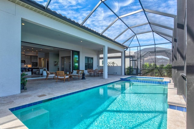 view of pool with glass enclosure, an outdoor hangout area, an in ground hot tub, and a patio