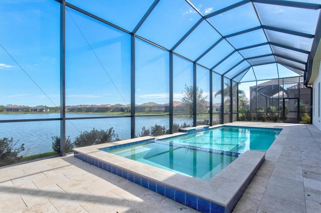 view of pool with glass enclosure, a water view, and a patio