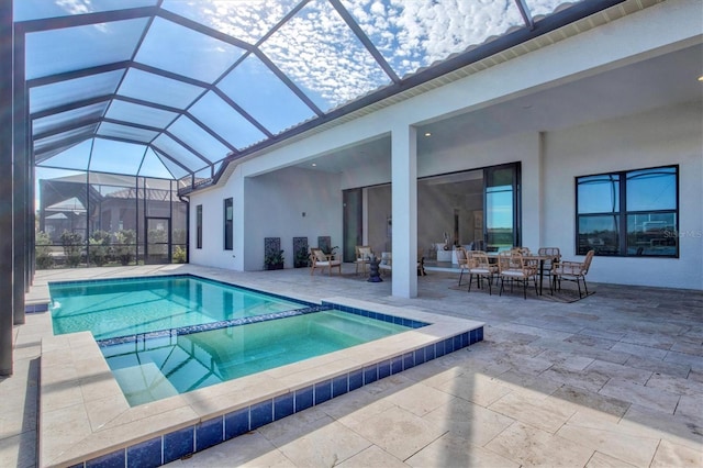 view of pool with glass enclosure and a patio area