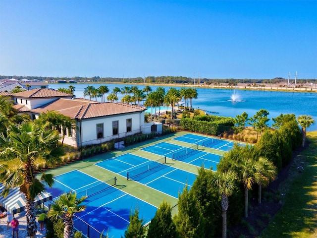 view of tennis court with a water view