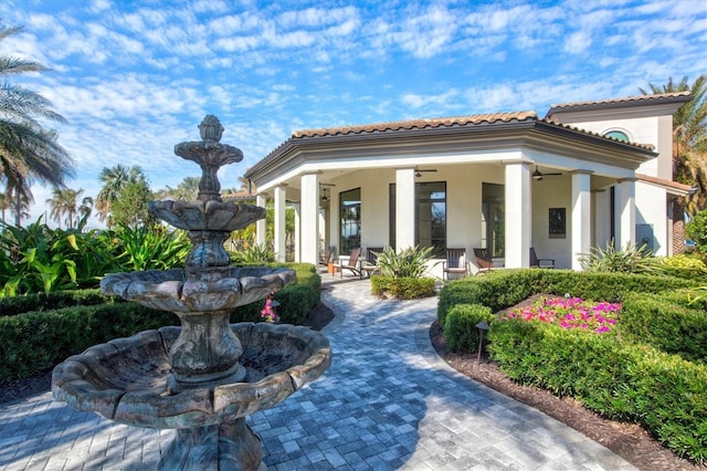 exterior space featuring ceiling fan