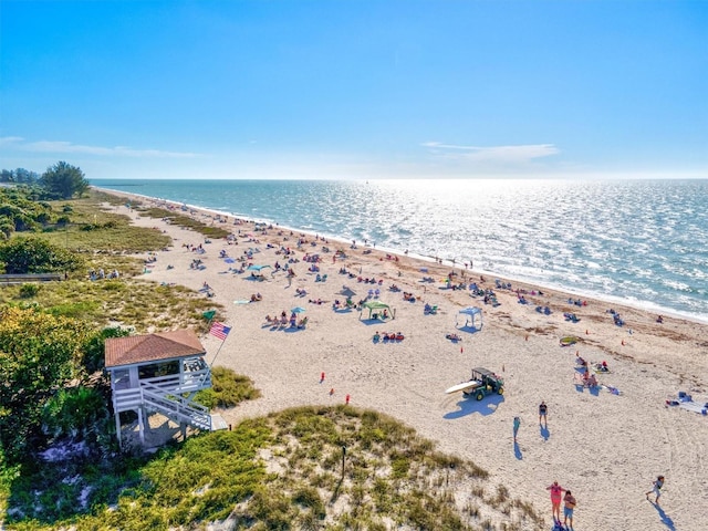 birds eye view of property featuring a beach view and a water view