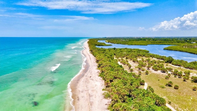 aerial view featuring a water view and a beach view