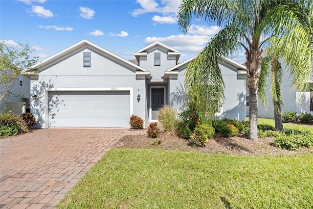 view of front facade with a front yard and a garage