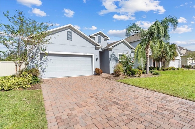 view of front of house featuring a garage and a front lawn