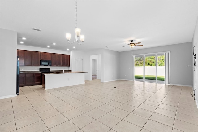 kitchen featuring an island with sink, pendant lighting, light tile patterned floors, black appliances, and ceiling fan with notable chandelier