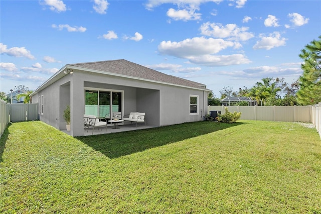 rear view of property with a lawn, central AC unit, and a patio