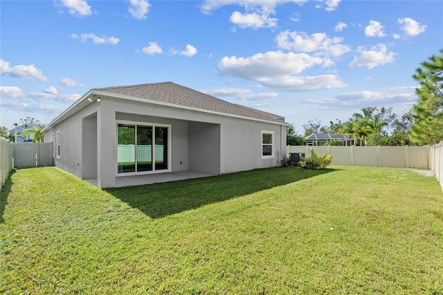 back of house featuring a lawn, central AC unit, and a patio