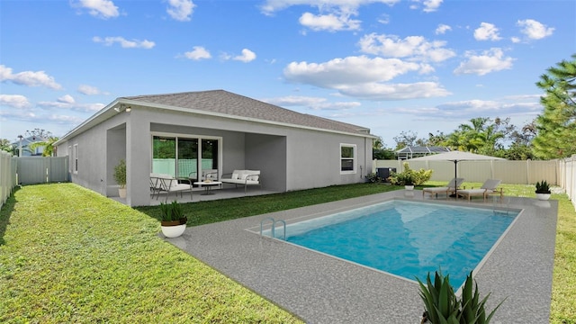 view of pool with outdoor lounge area, a yard, and a patio