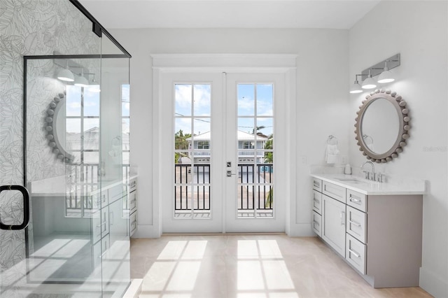 bathroom with french doors, vanity, and an enclosed shower