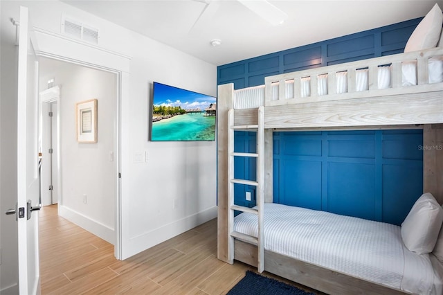 bedroom with light hardwood / wood-style flooring and ceiling fan