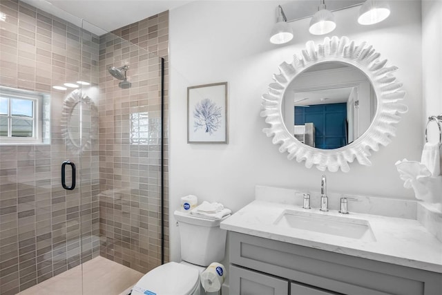 bathroom featuring vanity, toilet, and an enclosed shower