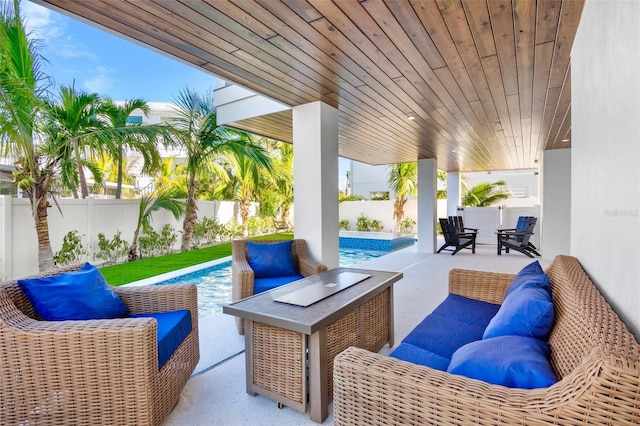 view of patio with outdoor lounge area and a fenced in pool