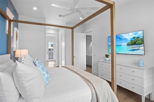 bedroom with dark hardwood / wood-style floors, ceiling fan, and ensuite bathroom