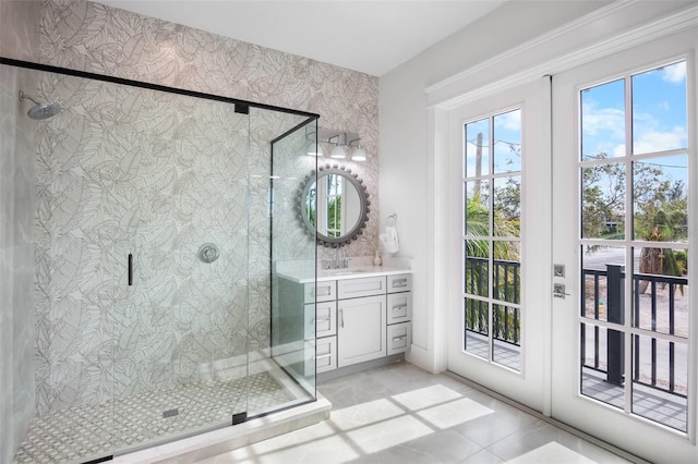 bathroom with tile patterned floors, vanity, and walk in shower