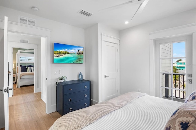 bedroom featuring access to outside, light hardwood / wood-style floors, and ceiling fan