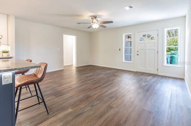 foyer with dark hardwood / wood-style flooring and ceiling fan