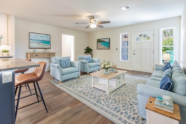 living room featuring hardwood / wood-style flooring and ceiling fan