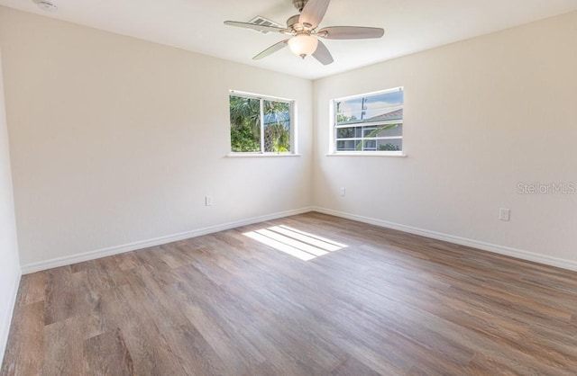 empty room with wood-type flooring and ceiling fan