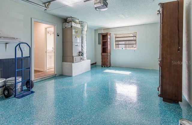 interior space featuring a textured ceiling and heating unit