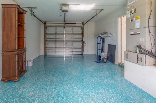 garage featuring a garage door opener and heating unit