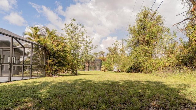 view of yard featuring glass enclosure