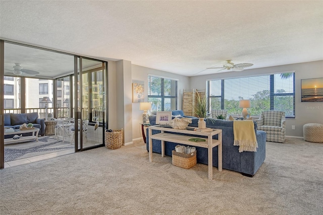 carpeted living room featuring a textured ceiling, a wealth of natural light, and ceiling fan