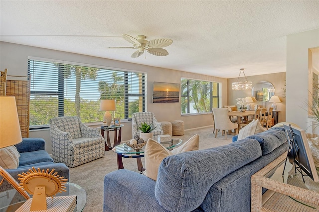 carpeted living room with ceiling fan with notable chandelier and a textured ceiling