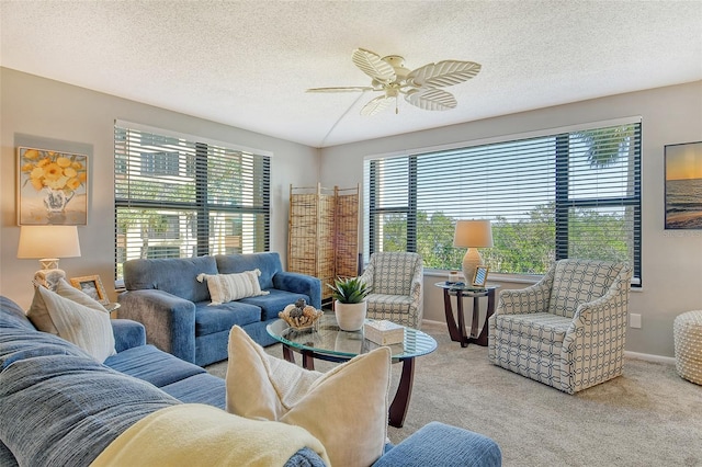 living room featuring ceiling fan, a healthy amount of sunlight, and light carpet