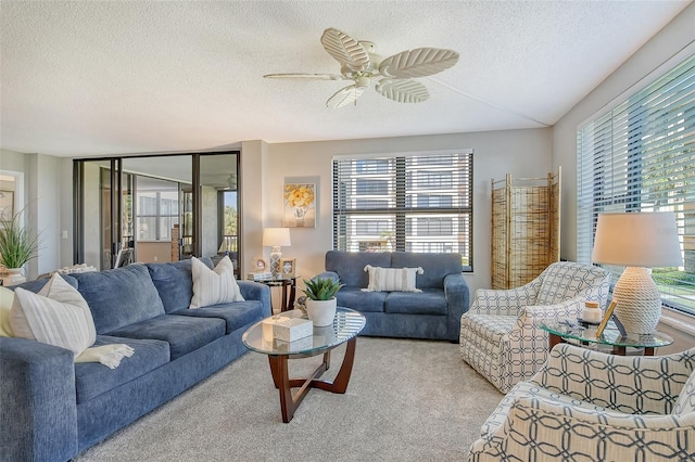 carpeted living room featuring a textured ceiling and ceiling fan