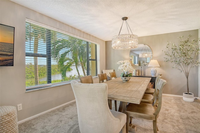 carpeted dining area featuring a textured ceiling and an inviting chandelier