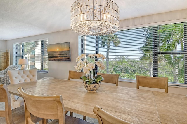 8779 Midnight Pass Rd Unit 206H, Sarasota, FL 34242 - dining area with a textured ceiling and a chandelier