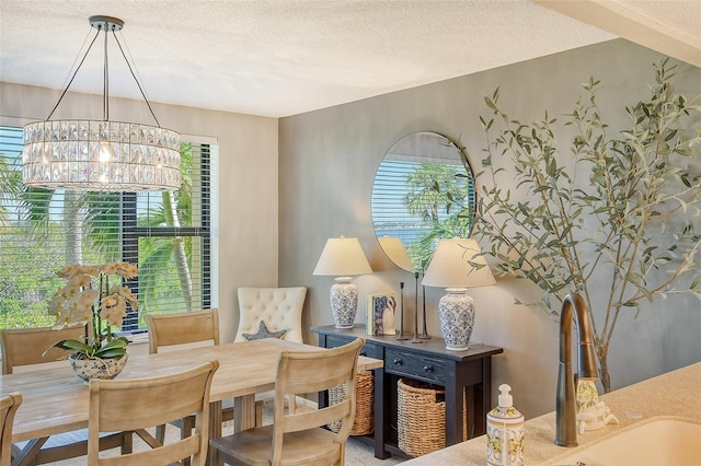 living area with a wealth of natural light, a textured ceiling, and an inviting chandelier