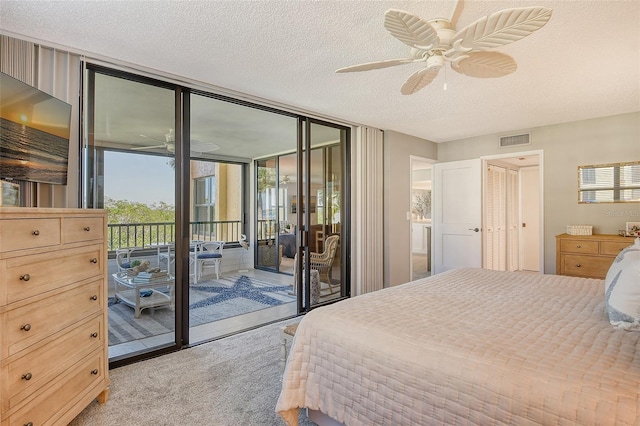 bedroom with floor to ceiling windows, a textured ceiling, access to outside, light colored carpet, and ceiling fan