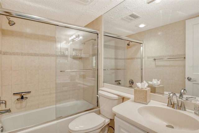 full bathroom featuring vanity, toilet, enclosed tub / shower combo, and a textured ceiling