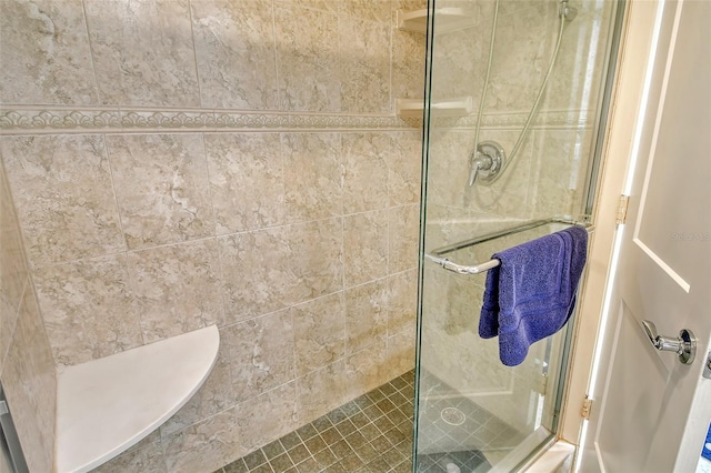 bathroom with a tile shower