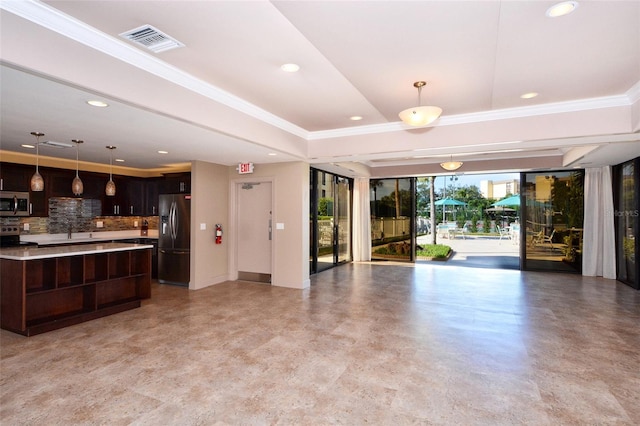 interior space with decorative backsplash, dark brown cabinets, hanging light fixtures, and appliances with stainless steel finishes