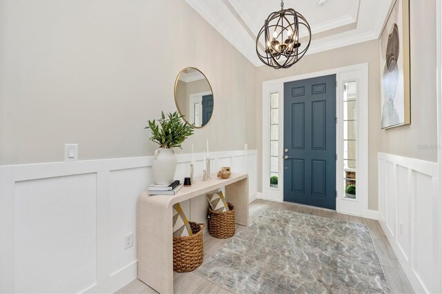 6249 Mesa Gln, Bradenton, FL 34203 - entryway featuring a chandelier, wood finished floors, ornamental molding, healthy amount of natural light, and a decorative wall