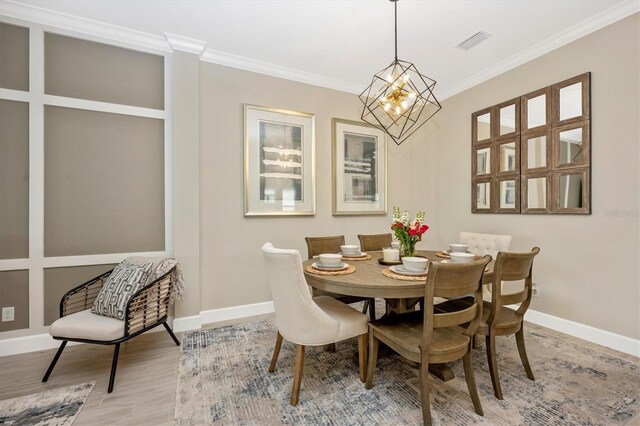 6249 Mesa Gln, Bradenton, FL 34203 - dining room with wood finished floors, baseboards, ornamental molding, and a chandelier