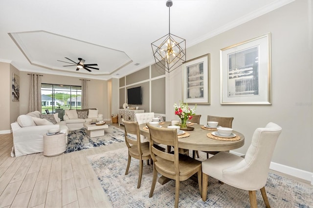 6249 Mesa Gln, Bradenton, FL 34203 - dining space featuring baseboards, wood finished floors, ornamental molding, ceiling fan, and a chandelier
