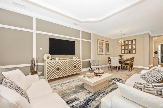 living room with a chandelier and crown molding