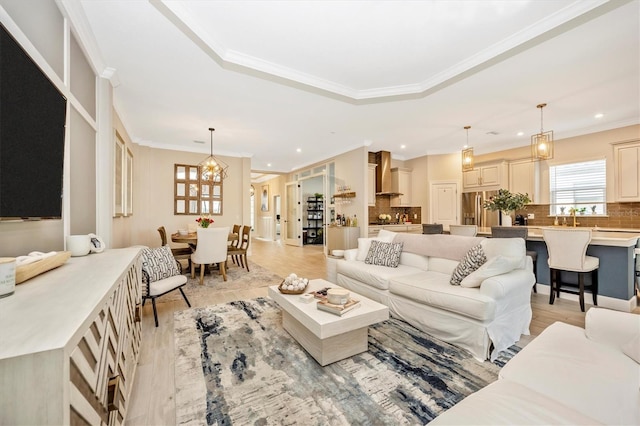 6249 Mesa Gln, Bradenton, FL 34203 - living area with light wood-style flooring, crown molding, recessed lighting, a chandelier, and a raised ceiling