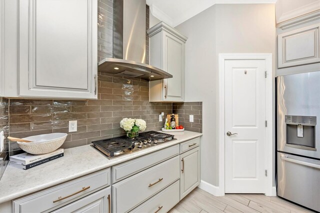 6249 Mesa Gln, Bradenton, FL 34203 - kitchen featuring appliances with stainless steel finishes, wall chimney exhaust hood, backsplash, light countertops, and ornamental molding