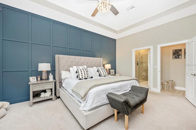6249 Mesa Gln, Bradenton, FL 34203 - bedroom featuring light colored carpet, a decorative wall, a ceiling fan, and connected bathroom