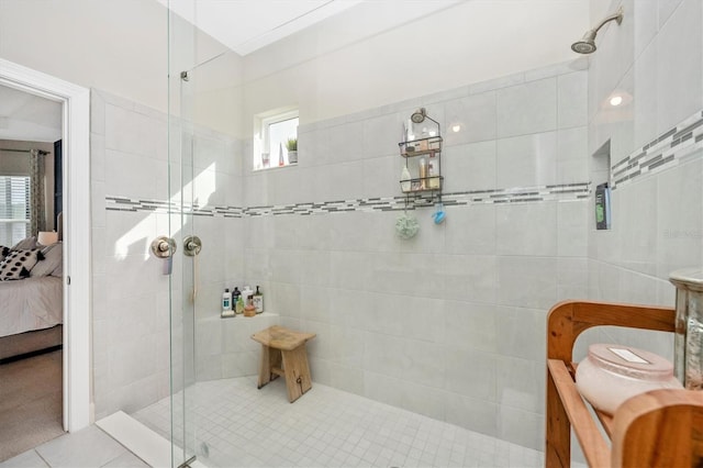 bathroom featuring tile patterned floors and a tile shower