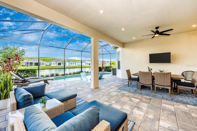 view of patio featuring an outdoor living space, a lanai, and ceiling fan