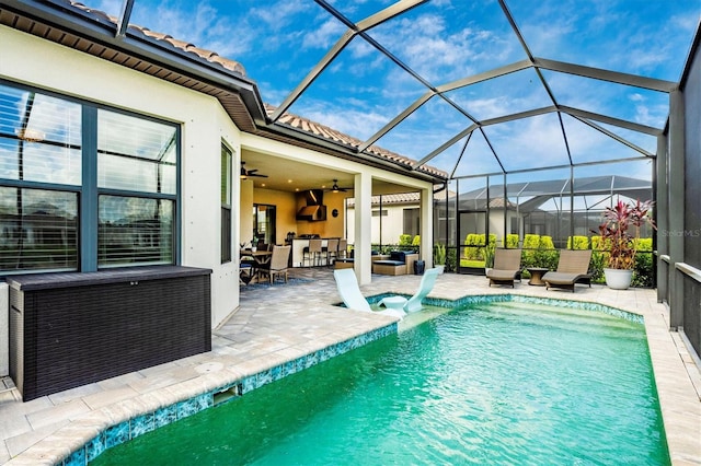 view of pool with ceiling fan, a patio, a lanai, and an outdoor living space