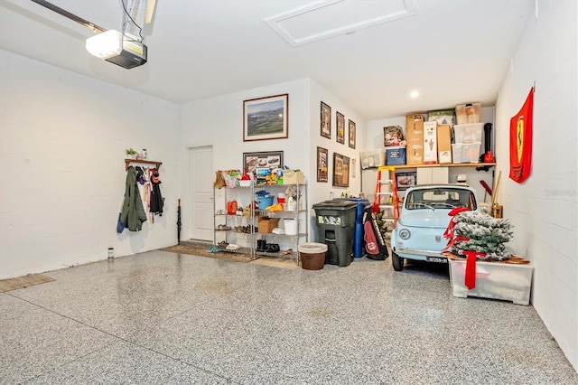 6249 Mesa Gln, Bradenton, FL 34203 - garage featuring a garage door opener and concrete block wall